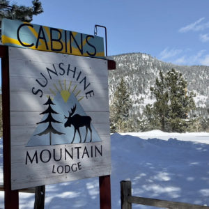 Sunshine Mountain Lodge sign in snow